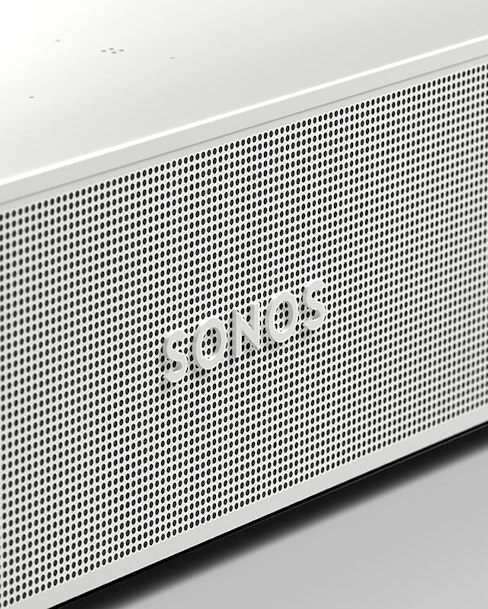 Close-up of a white Sonos speaker with a perforated mesh design.